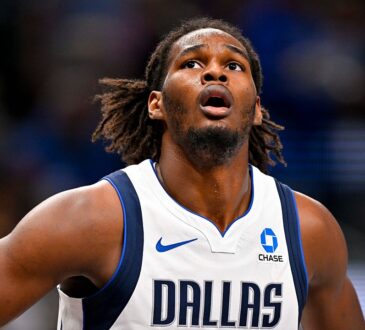 Dallas Mavericks forward Morez Johnson Jr. looks up toward the rim with his hands on his hips during a game.