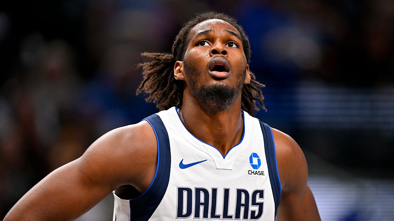 Dallas Mavericks forward Morez Johnson Jr. looks up toward the rim with his hands on his hips during a game.