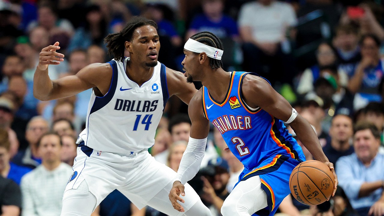 Mavericks forward Morez Johnson Jr. guards Thunder guard Shai Gilgeous-Alexander as he dribbles.