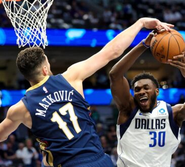 Dallas Mavericks center Moussa Cisse goes up with the ball as New Orleans Pelicans forward Karlo Matković reaches to block it.