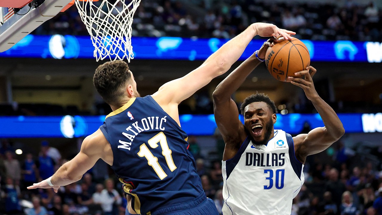 Dallas Mavericks center Moussa Cisse goes up with the ball as New Orleans Pelicans forward Karlo Matković reaches to block it.