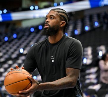 Mavericks forward Naji Marshall holds a basketball during pregame warmups.