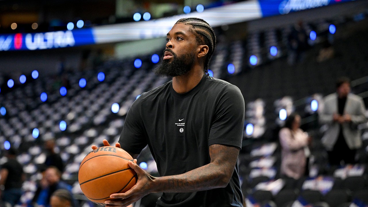 Mavericks forward Naji Marshall holds a basketball during pregame warmups.