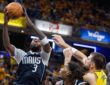 Mavericks forward Naji Marshall rises for a shot as Pacers center Ivica Zubac reaches to defend.