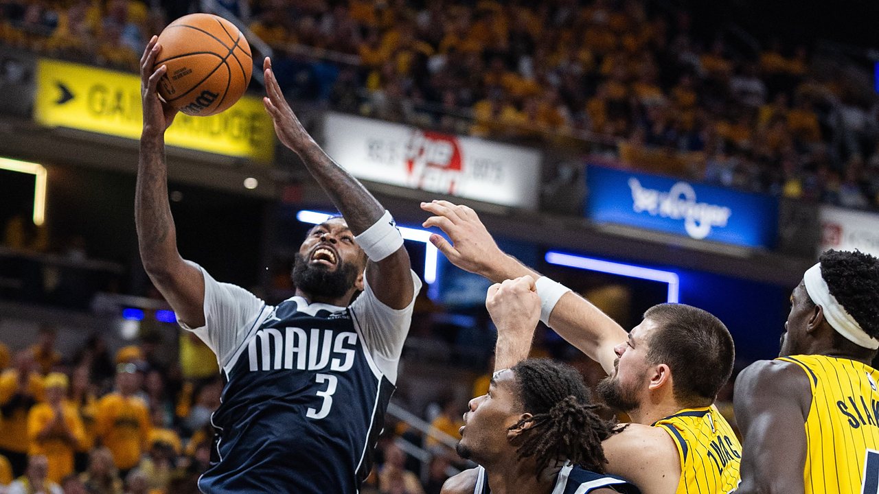 Mavericks forward Naji Marshall rises for a shot as Pacers center Ivica Zubac reaches to defend.
