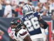 Texans wide receiver Nico Collins kneels in the end zone with the ball as Cowboys cornerback DaRon Bland turns away.