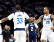 Dallas Mavericks forward P.J. Washington slaps hands with forward Tobi Lawal, who has his back to the camera.