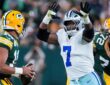 Dallas Cowboys linebacker Rashan Gary rushes with both arms raised toward Green Bay Packers quarterback Jordan Love.