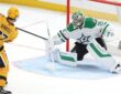 Penguins right wing Rickard Rakell shoots past Stars goaltender Jake Oettinger, who stretches into a split in the crease.