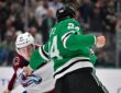 Stars center Roope Hintz grabs the jersey of Avalanche center Nathan MacKinnon and cocks his fist during a fight.