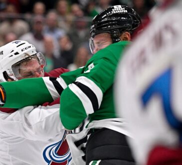 Stars center Roope Hintz throws a punch as Avalanche center Nathan MacKinnon ducks his head during a fight.