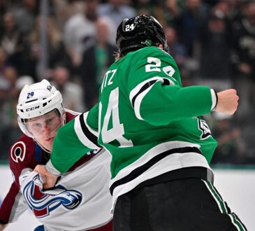 Stars center Roope Hintz grabs the jersey of Avalanche center Nathan MacKinnon and cocks his fist during a fight.