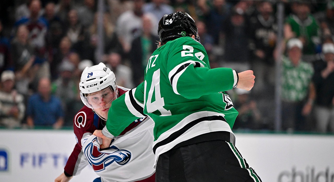 Stars center Roope Hintz grabs the jersey of Avalanche center Nathan MacKinnon and cocks his fist during a fight.