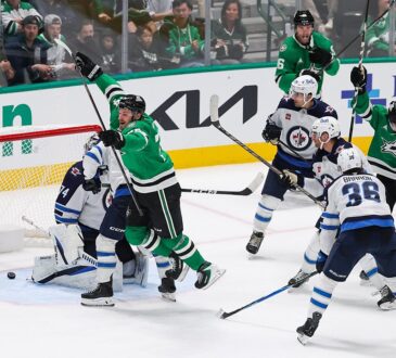 Dallas Stars center Roope Hintz leaps in celebration as the puck sits behind Winnipeg Jets goaltender Stuart Skinner.