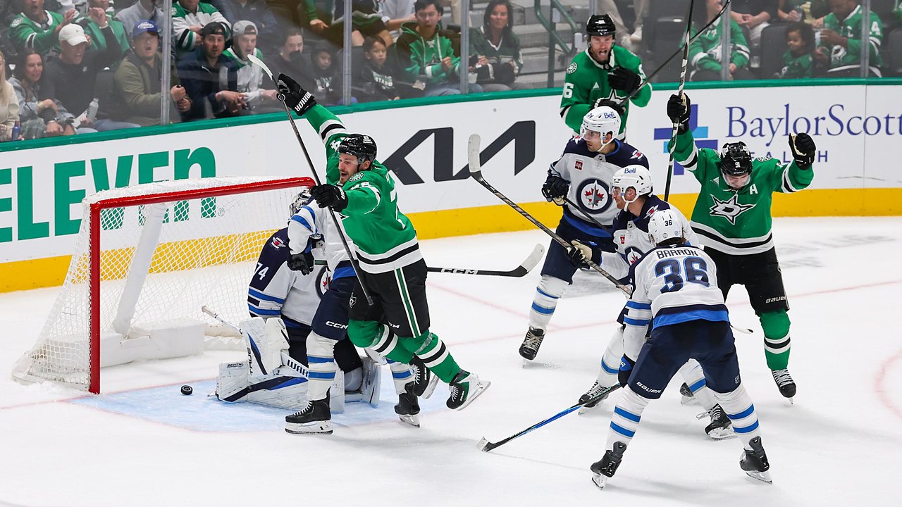 Dallas Stars center Roope Hintz leaps in celebration as the puck sits behind Winnipeg Jets goaltender Stuart Skinner.