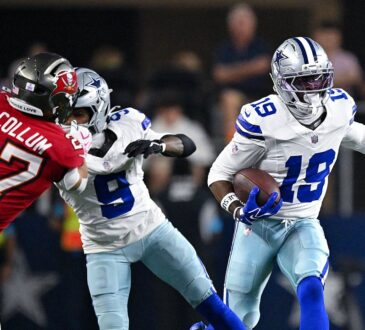 Dallas Cowboys wide receiver Ryan Flournoy carries the ball as teammate KaVontae Turpin blocks Tampa Bay Buccaneers cornerback Zyon McCollum.
