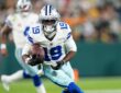Dallas Cowboys wide receiver Ryan Flournoy cuts upfield with the ball tucked in his right arm.