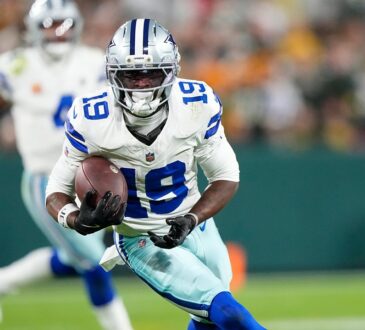 Dallas Cowboys wide receiver Ryan Flournoy cuts upfield with the ball tucked in his right arm.