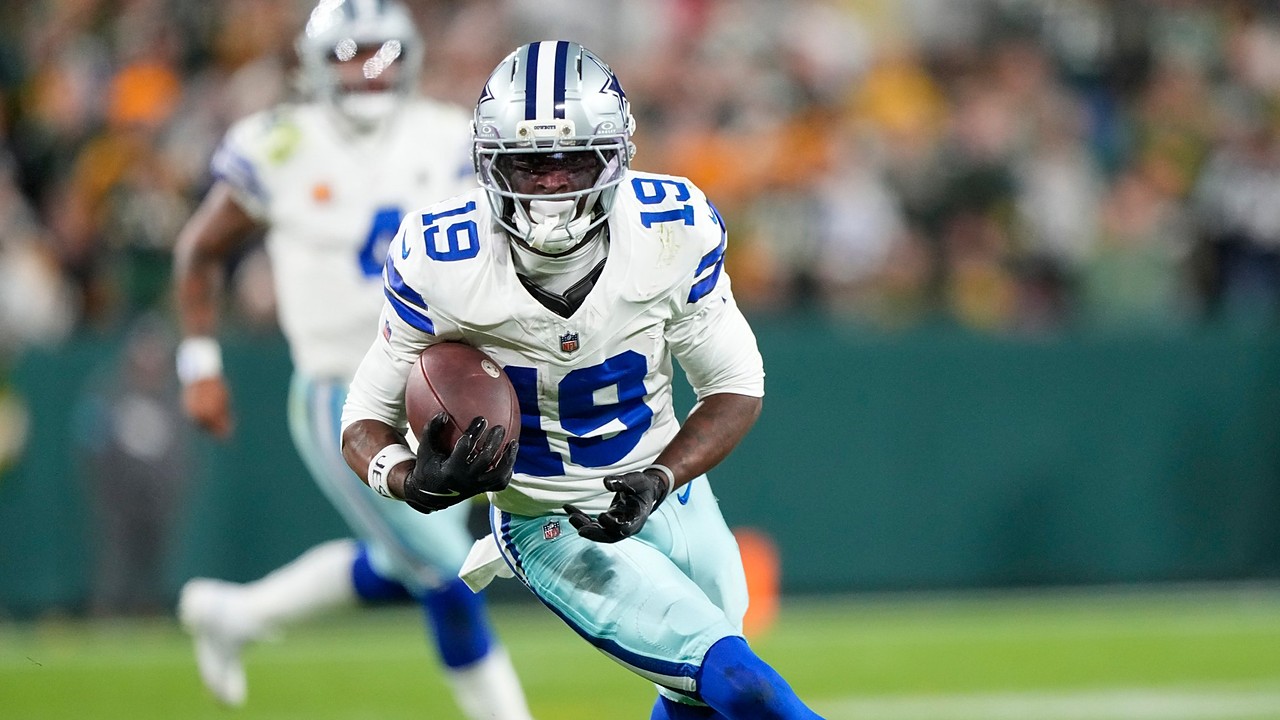 Dallas Cowboys wide receiver Ryan Flournoy cuts upfield with the ball tucked in his right arm.