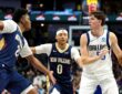 Dallas Mavericks guard Sergio de Larrea holds the ball as Pelicans guard Jeremiah Fears and center Derik Queen defend.