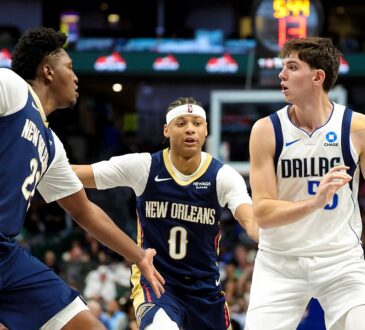 Dallas Mavericks guard Sergio de Larrea holds the ball as Pelicans guard Jeremiah Fears and center Derik Queen defend.