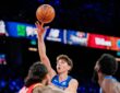 Mavericks guard Sergio De Larrea releases a floater over Rockets defenders, eyes locked on the ball.