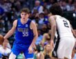 Dallas Mavericks guard Sergio de Larrea dribbles with his right hand as San Antonio Spurs guard Dylan Harper guards him.
