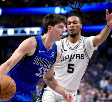 Dallas Mavericks guard Sergio de Larrea drives with the ball as San Antonio Spurs guard Stephon Castle defends with an arm raised.