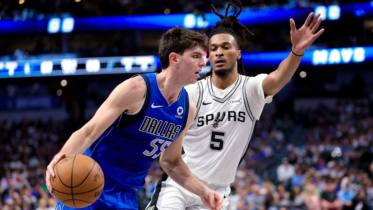 Dallas Mavericks guard Sergio de Larrea drives with the ball as San Antonio Spurs guard Stephon Castle defends with an arm raised.
