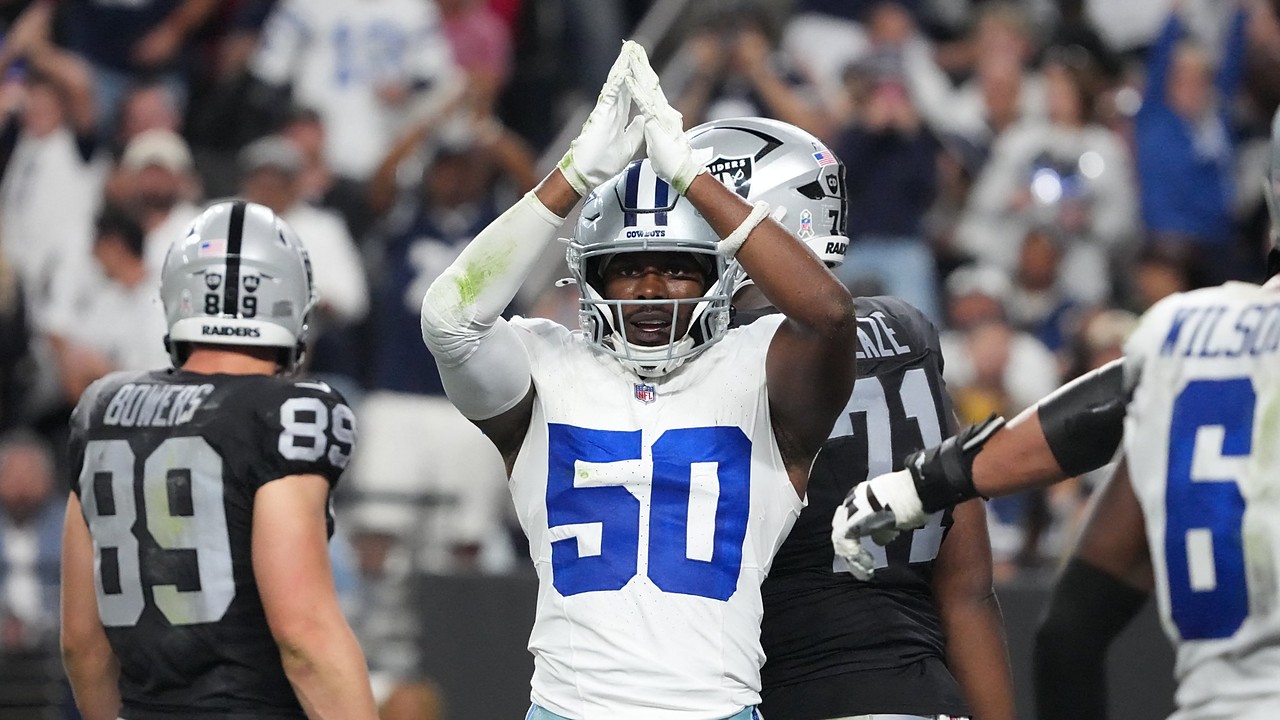 Dallas Cowboys linebacker Shemar James raises both hands over his helmet in a safety signal as Raiders players walk away.