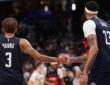 Washington Wizards guard Trae Young #3 celebrates with forward Anthony Davis #23 in the final minute against the Milwaukee Bucks at Capital One Arena.