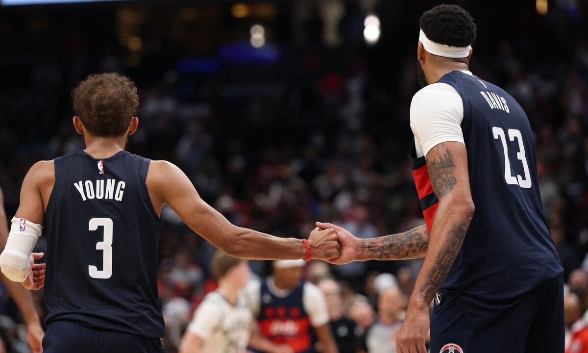 Washington Wizards guard Trae Young #3 celebrates with forward Anthony Davis #23 in the final minute against the Milwaukee Bucks at Capital One Arena.