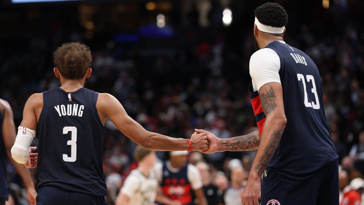 Washington Wizards guard Trae Young #3 celebrates with forward Anthony Davis #23 in the final minute against the Milwaukee Bucks at Capital One Arena.