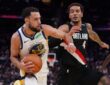 Golden State Warriors forward Tyler Burton drives with the ball as then-Portland Trail Blazers forward Jeremy Sochan defends.