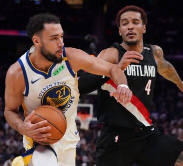 Golden State Warriors forward Tyler Burton drives with the ball as then-Portland Trail Blazers forward Jeremy Sochan defends.
