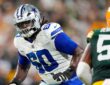 Dallas Cowboys offensive tackle Tyler Guyton slides into pass protection as a Green Bay Packers defender rushes in.