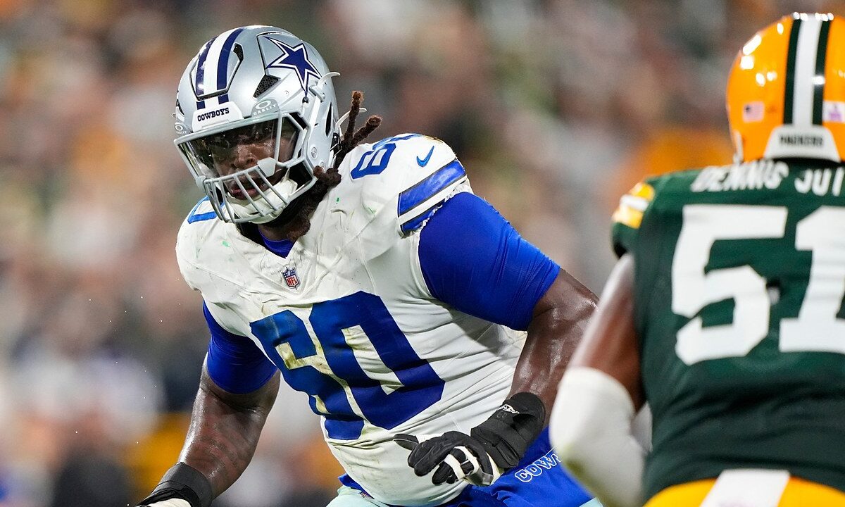 Dallas Cowboys offensive tackle Tyler Guyton slides into pass protection as a Green Bay Packers defender rushes in.
