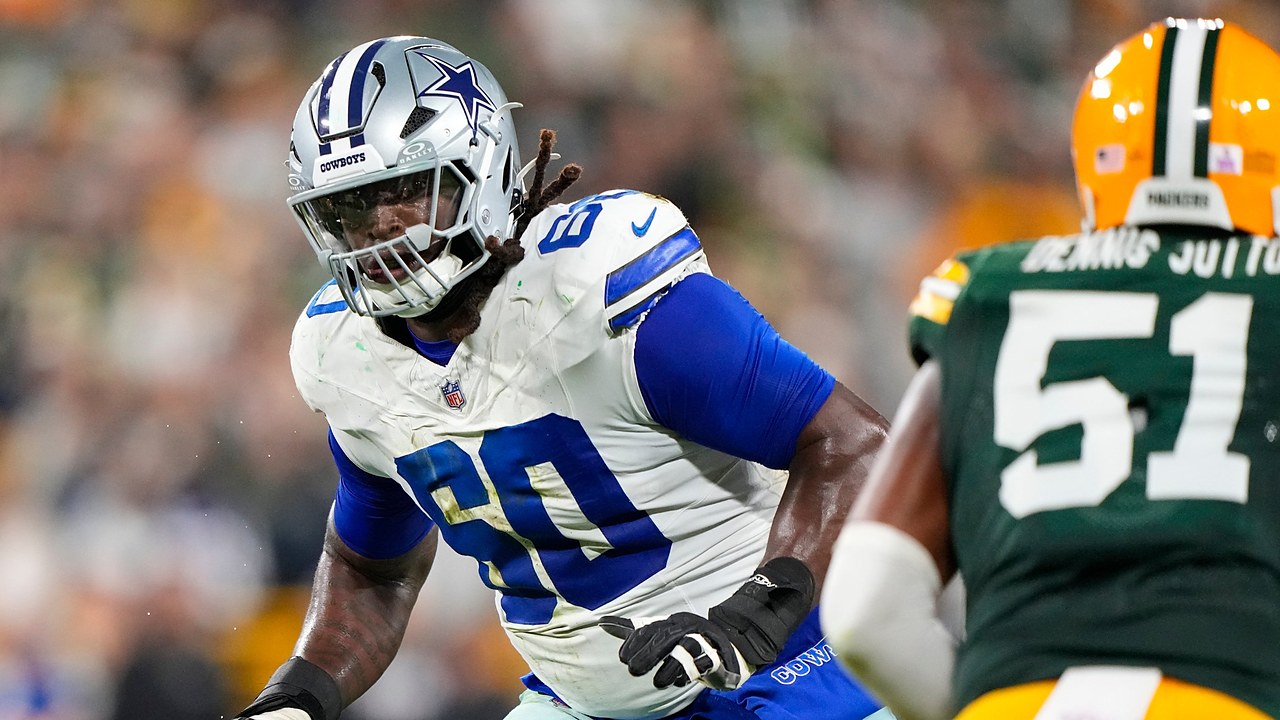 Dallas Cowboys offensive tackle Tyler Guyton slides into pass protection as a Green Bay Packers defender rushes in.