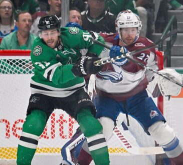 Stars center Tyler Seguin fights for position against Avalanche defenseman Brett Kulak in front of the Colorado net.