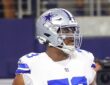 Cowboys guard Tyler Smith walks on the field during pregame warmups.