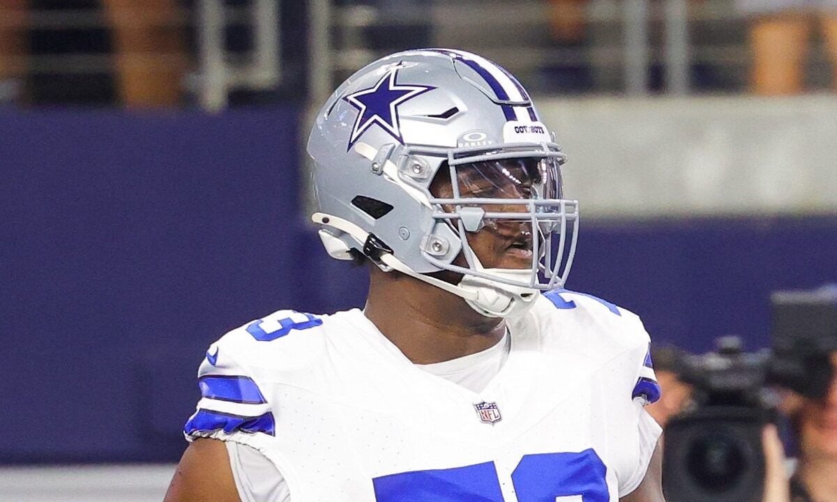 Cowboys guard Tyler Smith walks on the field during pregame warmups.