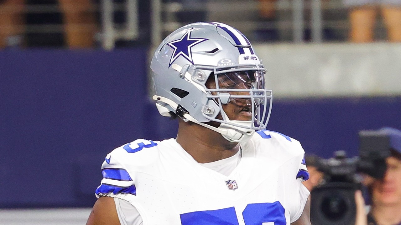 Cowboys guard Tyler Smith walks on the field during pregame warmups.