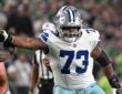 Cowboys guard Tyler Smith extends his right arm to block an Eagles defender at the line of scrimmage.