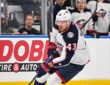 Blue Jackets right wing Valeri Nichushkin skates with the puck along the boards.