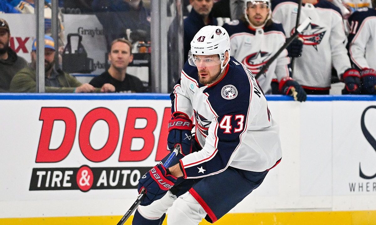Blue Jackets right wing Valeri Nichushkin skates with the puck along the boards.