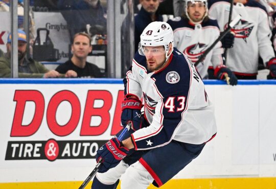 Blue Jackets right wing Valeri Nichushkin skates with the puck along the boards.