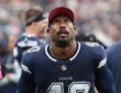 Cowboys outside linebacker Von Miller looks up from the sideline.