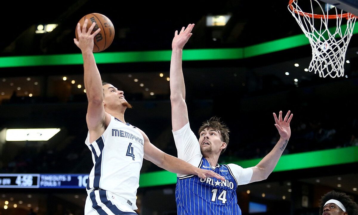 Memphis Grizzlies guard Walter Clayton Jr. rises for a one-handed layup as Orlando Magic center Colin Castleton reaches to contest.