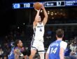 Memphis Grizzlies guard Walter Clayton Jr. rises for a jump shot as two Orlando Magic defenders look on.
