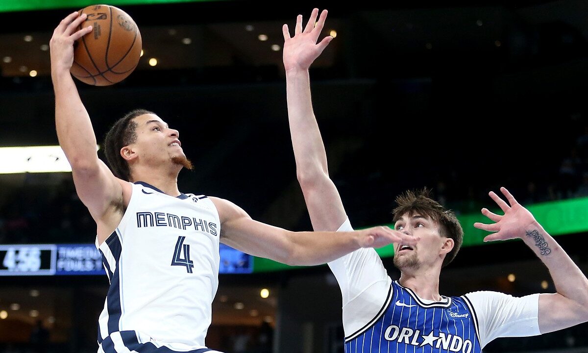 Memphis Grizzlies guard Walter Clayton Jr. rises for a one-handed layup as Orlando Magic center Colin Castleton reaches to contest.